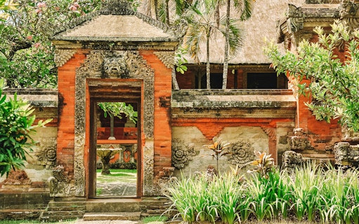 Traditional Balinese temple gate with intricate carvings in Denpasar, Bali.