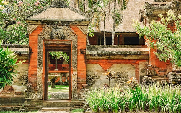 Traditional Balinese temple gate with intricate carvings in Denpasar, Bali.