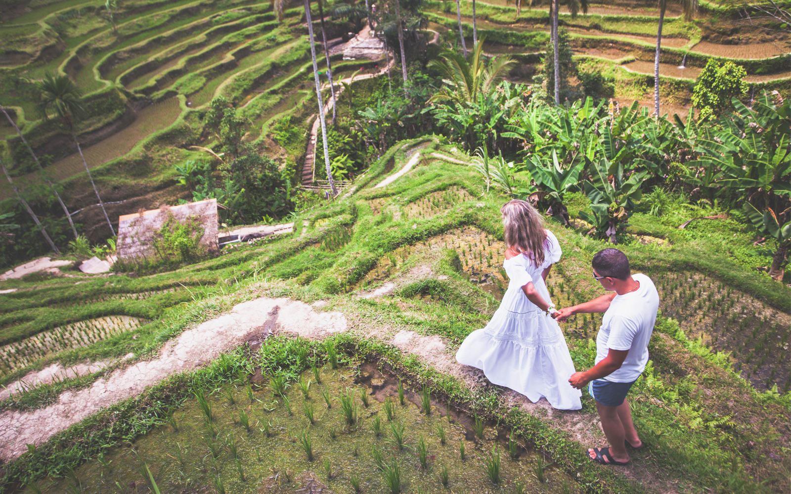 Couple walking through lush rice terraces in Bali during Instagram tour.