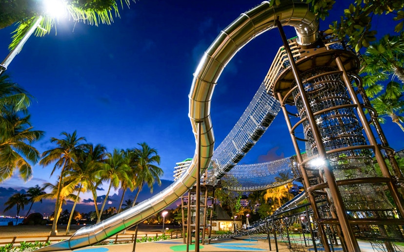 Outdoor playground with slides and climbing nets at Nestopia Singapore.