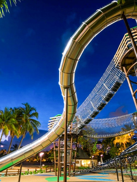 Outdoor playground with slides and climbing nets at Nestopia Singapore.