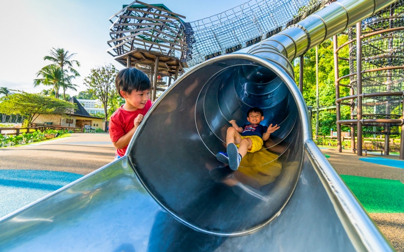 Children playing on a slide at Nestopia Singapore playground.