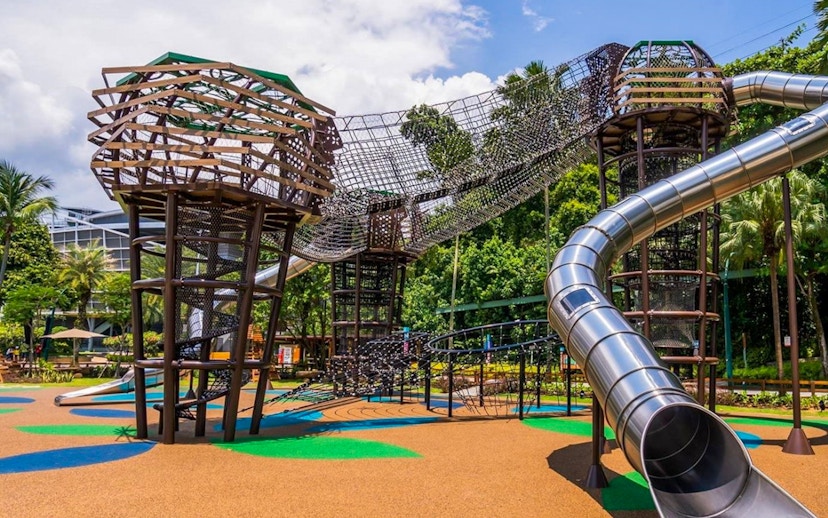 Outdoor playground with climbing structures and slides at Nestopia Singapore.