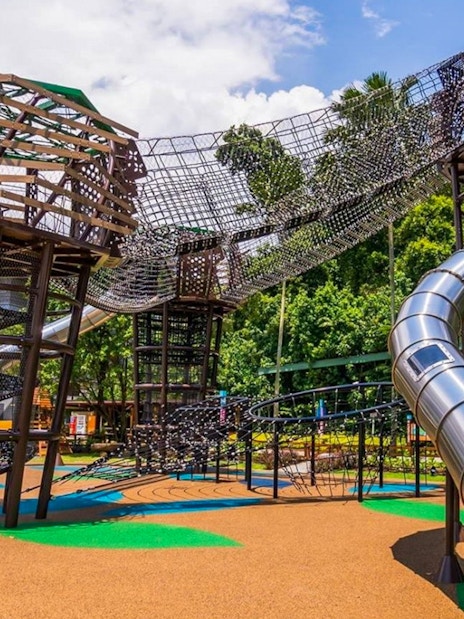 Outdoor playground with climbing structures and slides at Nestopia Singapore.