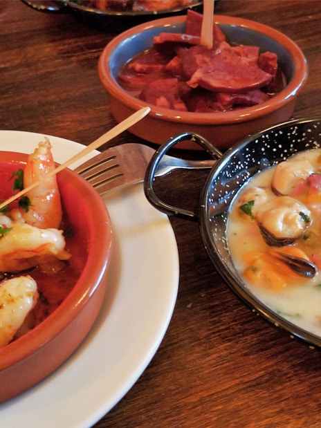 Tapas dishes with shrimp, chorizo, and mussels in Triana tour.