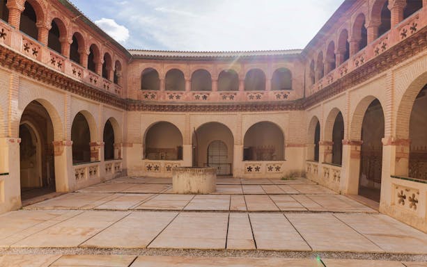 Courtyard with arches at the Ruins of Italica during a guided tour.