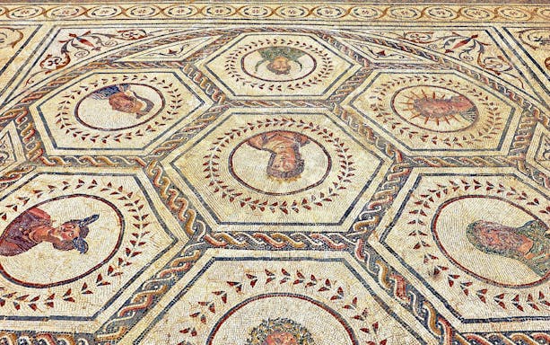 Mosaic floor with intricate designs at the Ruins of Italica, Spain.