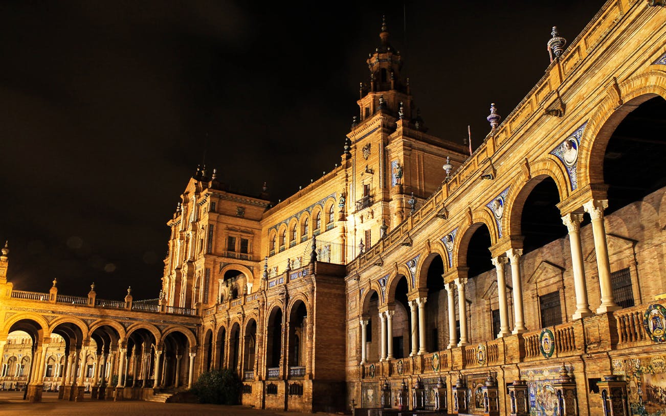 Plaza de España illuminated at night, featured on the Enchanted Seville Walking Tour.