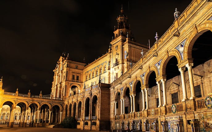 Plaza de España illuminated at night, featured on the Enchanted Seville Walking Tour.