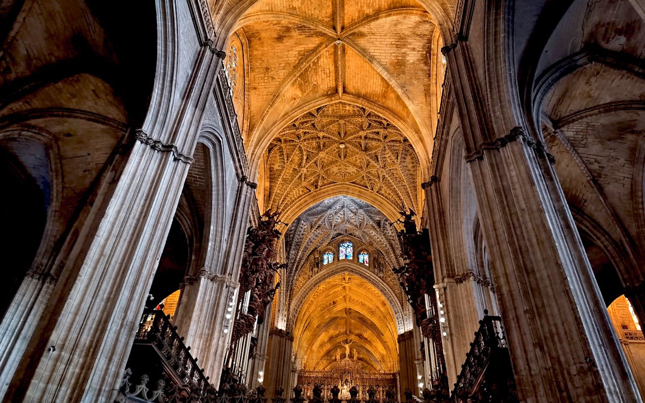 Seville Cathedral's intricate Gothic arches and vaulted ceiling.