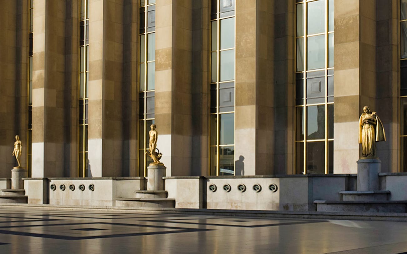 Exterior view of Musée de l'Homme with statues and columns, Paris.