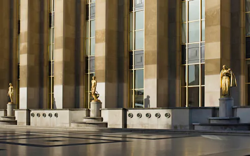 Exterior view of Musée de l'Homme with statues and columns, Paris.