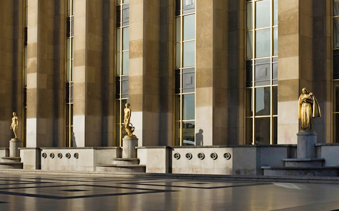 Exterior view of Musée de l'Homme with statues and columns, Paris.