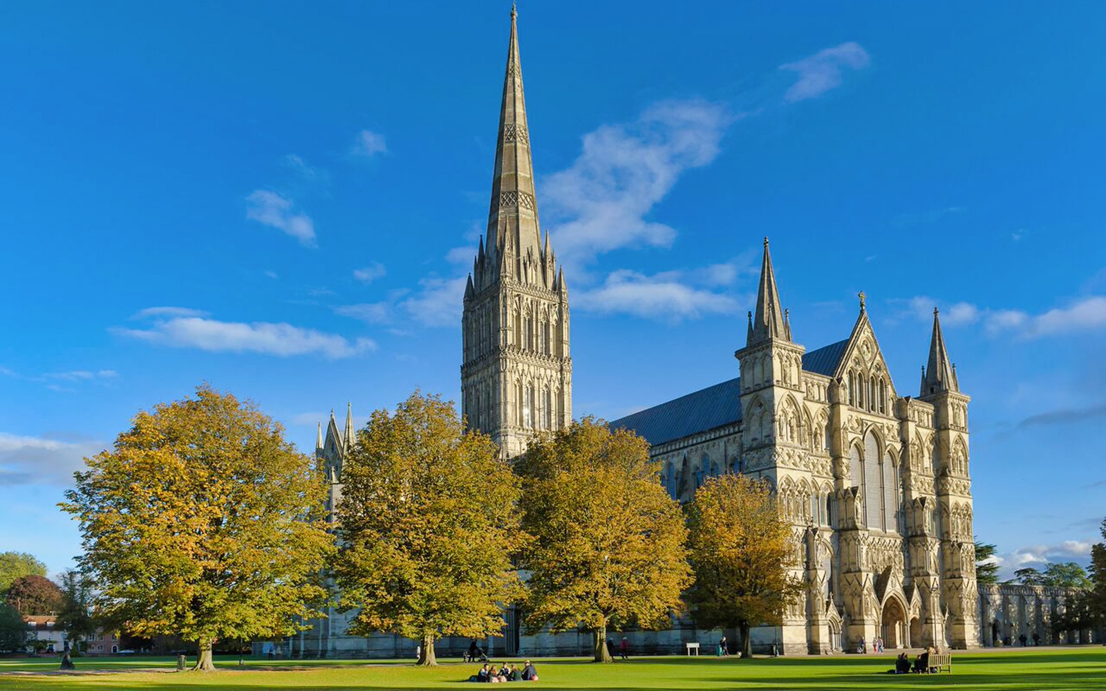 Salisbury Cathedral exterior with visitors holding entry tickets in London.