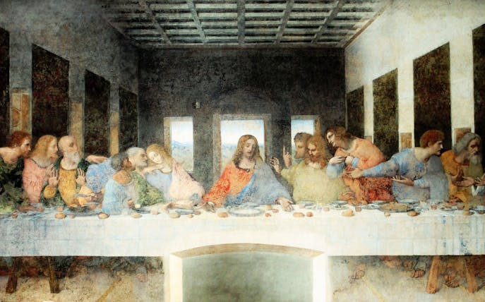 Da Vinci's Last Supper mural in Milan, Italy, depicting Jesus and disciples at a long table.