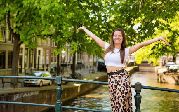 Person enjoying a canal view on the Amstagram Tour in Amsterdam.