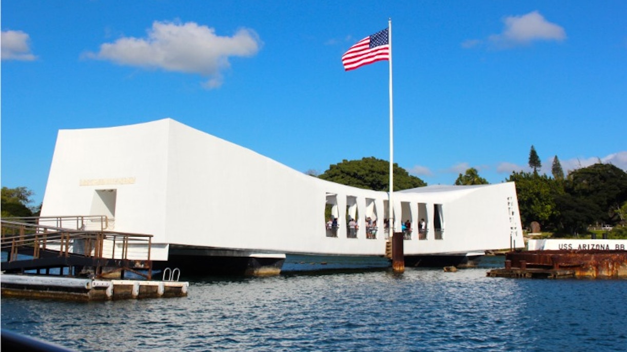 USS Arizona Memorial at Pearl Harbor with American flag, Hawaii.