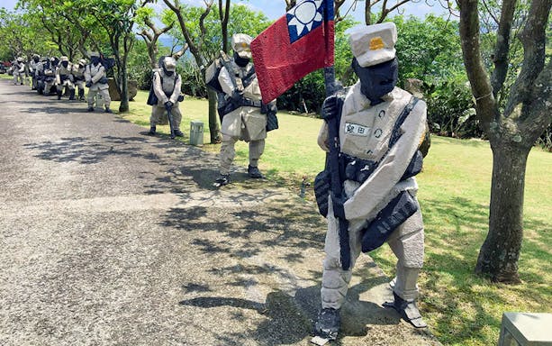 Sculptures of soldiers with a flag at Jinshan JuMing Museum, Taiwan.