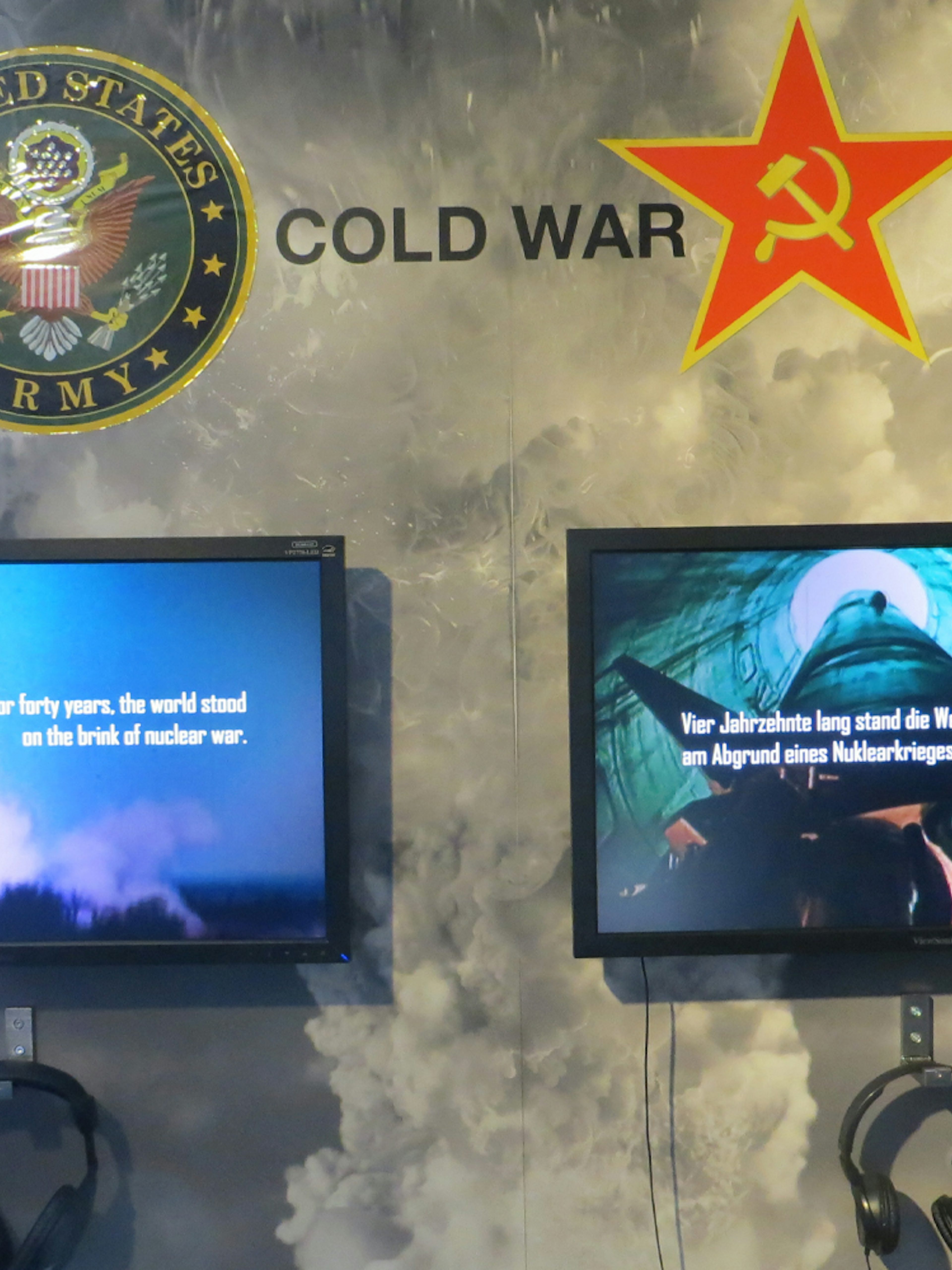 Cold War exhibit with US Army and Soviet symbols at The Wall Museum East Side Gallery.