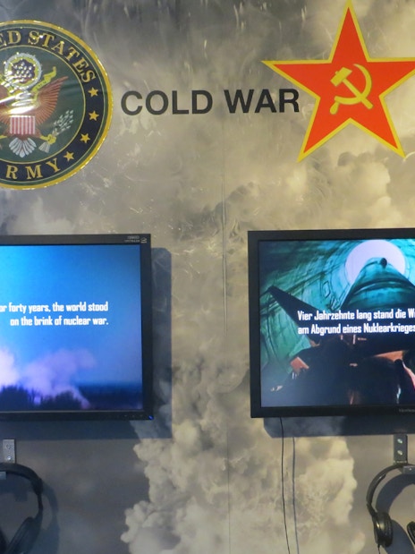 Cold War exhibit with US Army and Soviet symbols at The Wall Museum East Side Gallery.