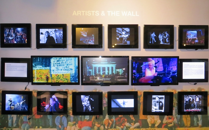Wall Museum East Side Gallery exhibit featuring multimedia displays of artists and Berlin Wall history.