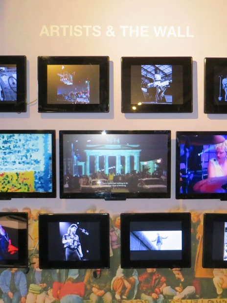 Wall Museum East Side Gallery exhibit featuring multimedia displays of artists and Berlin Wall history.