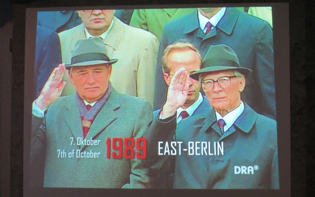 Historical leaders saluting in East Berlin, 1989, at The Wall Museum East Side Gallery.
