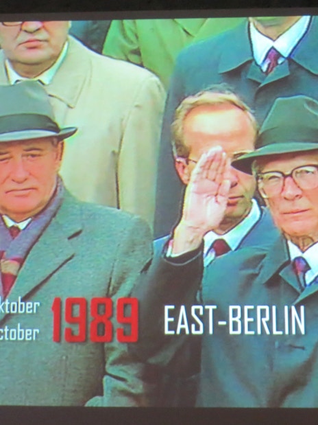 Historical leaders saluting in East Berlin, 1989, at The Wall Museum East Side Gallery.