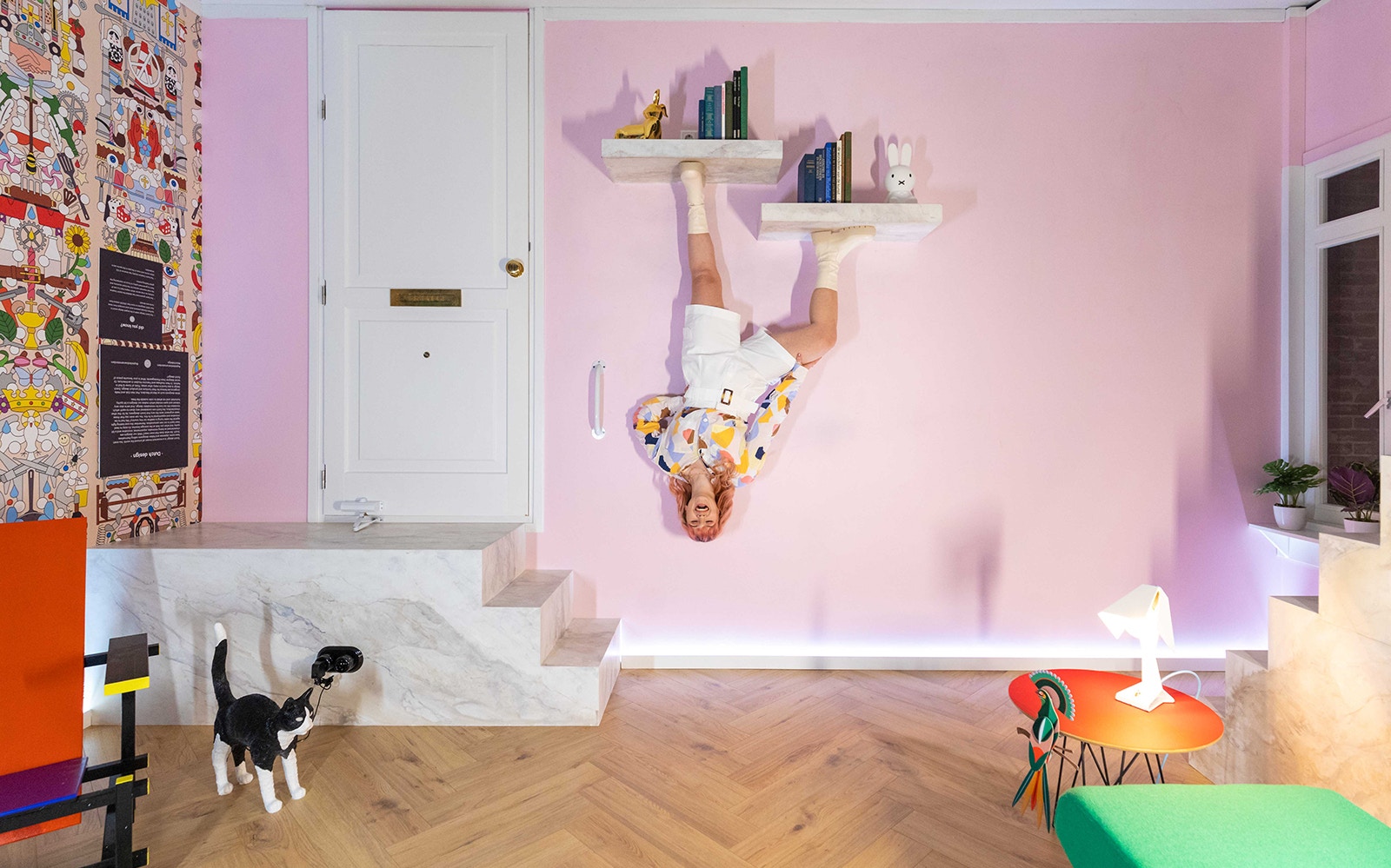 Visitors in Dutch Design Room at Upside Down Amsterdam with playful decor.