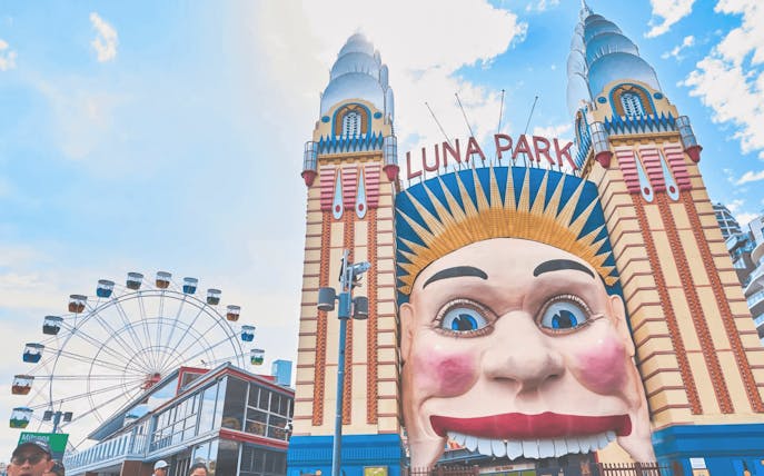 Luna Park Sydney entrance with iconic face and Ferris wheel in background.