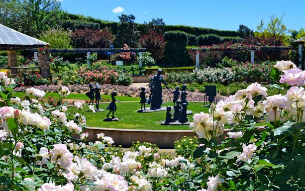 Hunter Valley Gardens with sculptures and blooming flowers in a vibrant landscape.