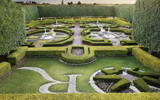 Hunter Valley Gardens with intricate hedges and fountains in a symmetrical layout.