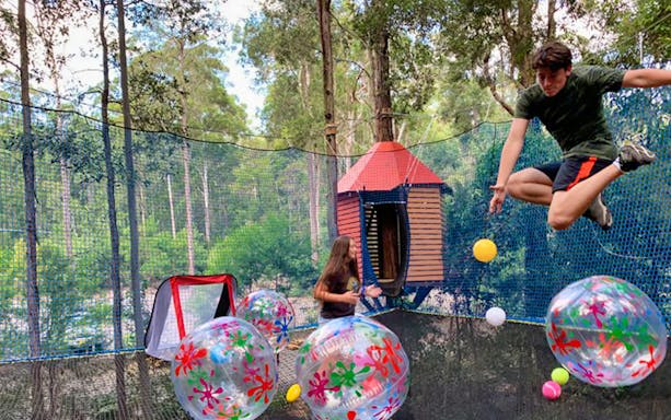 Children playing with colorful balls at Treetops Adventure Park.