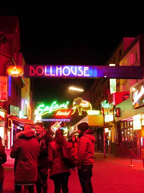 St. Pauli nightlife scene with neon signs and people on the street, Hamburg.