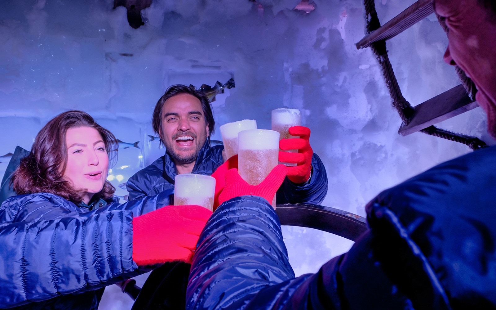 Amsterdam Xtracold Icebar interior with ice sculptures and patrons enjoying drinks.