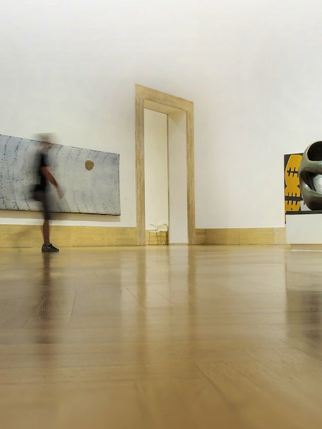 Modern art gallery interior at Palazzo Barberini, featuring abstract sculptures and paintings.