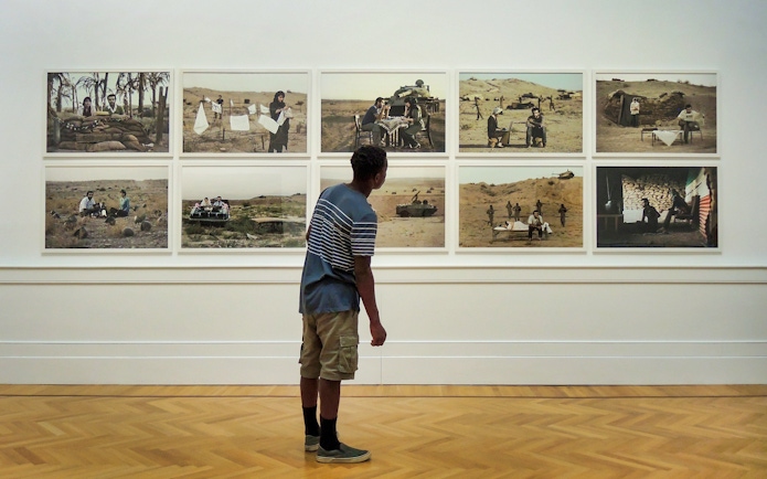 Visitor viewing modern art photography at Galleria Arte Moderna Nazionale.