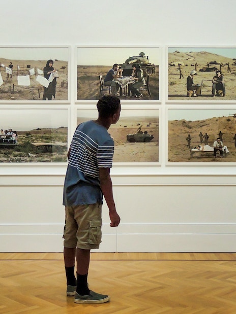 Visitor viewing modern art photography at Galleria Arte Moderna Nazionale.