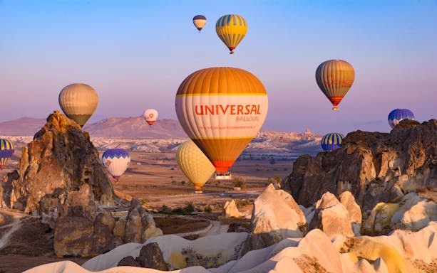 Hot air balloons flying over the Fairy Chimneys in Cappadocia, Turkey.