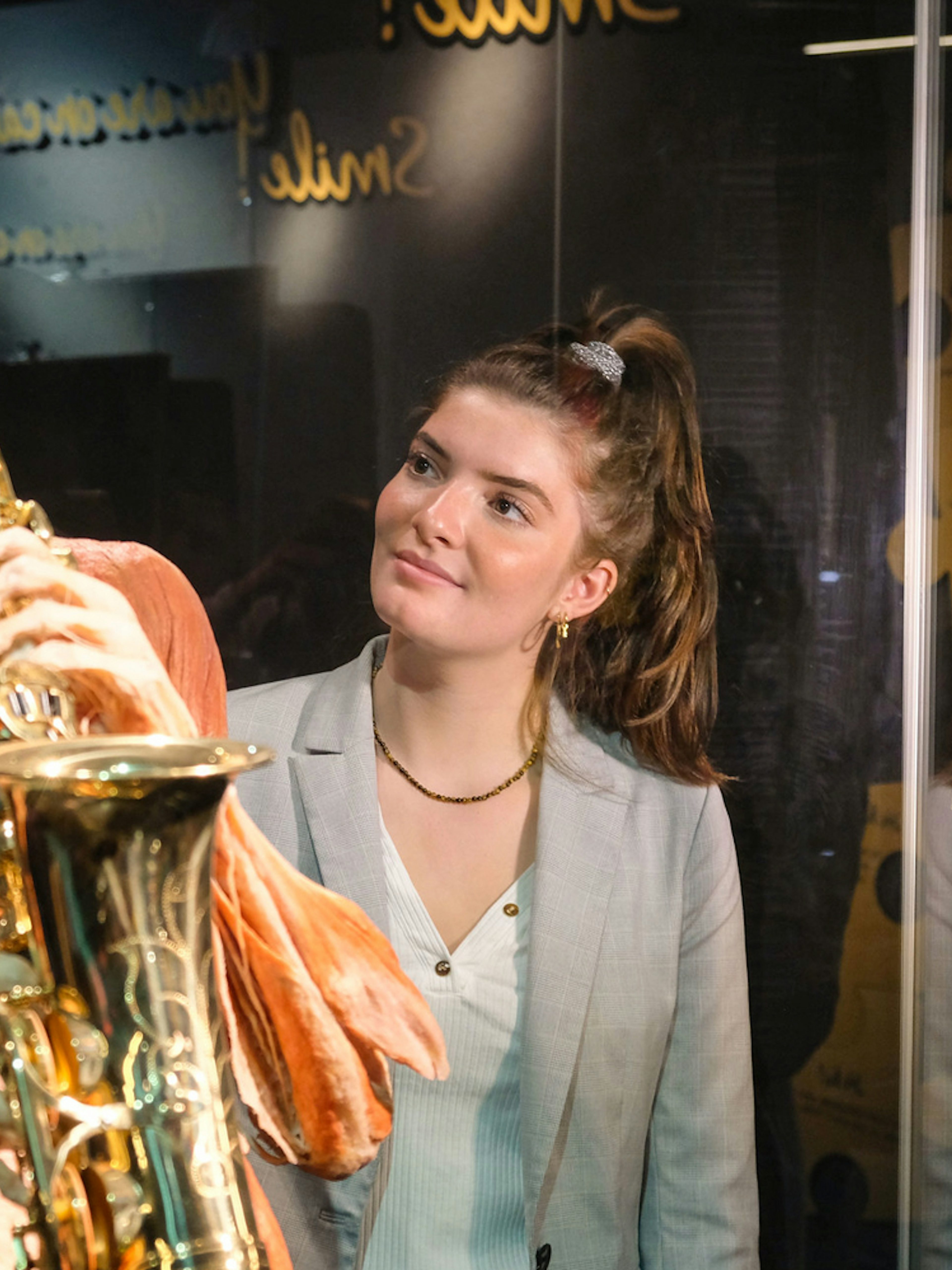 Sculpted human figure playing saxophone at Body Worlds Amsterdam exhibit.