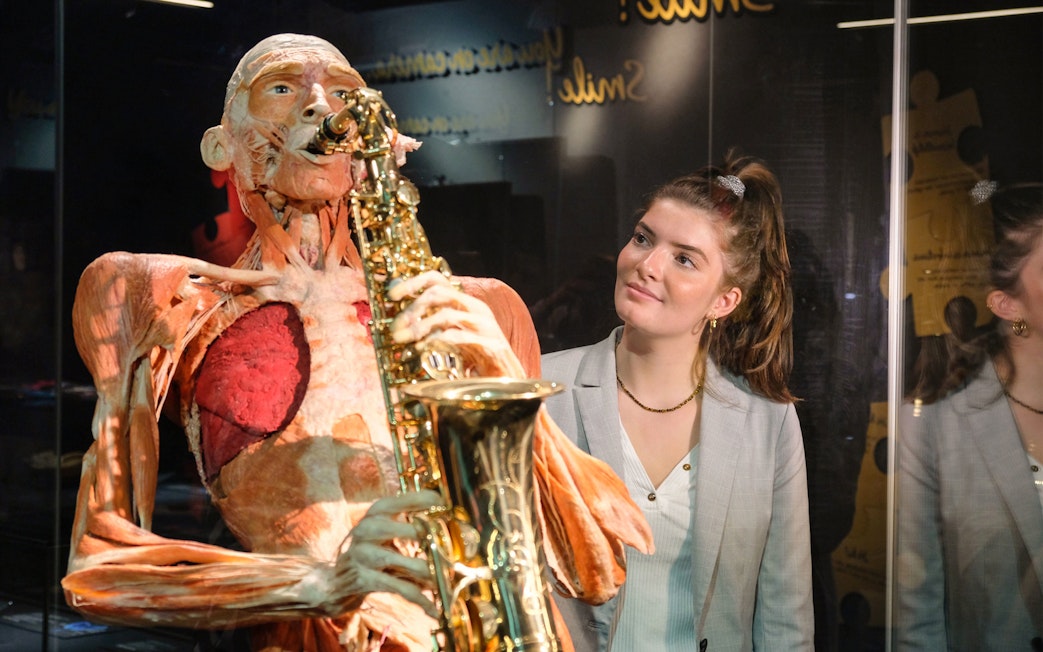 Sculpted human figure playing saxophone at Body Worlds Amsterdam exhibit.