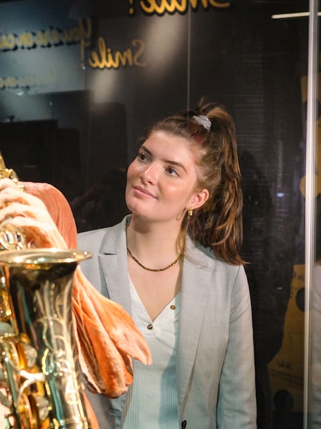 Sculpted human figure playing saxophone at Body Worlds Amsterdam exhibit.