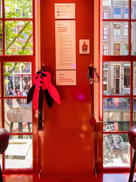 Interior view of Red Light Secrets Museum of Prostitution with window overlooking Amsterdam street.