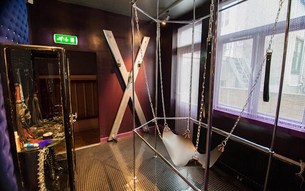 Museum of Prostitution exhibit with bondage equipment and display case.