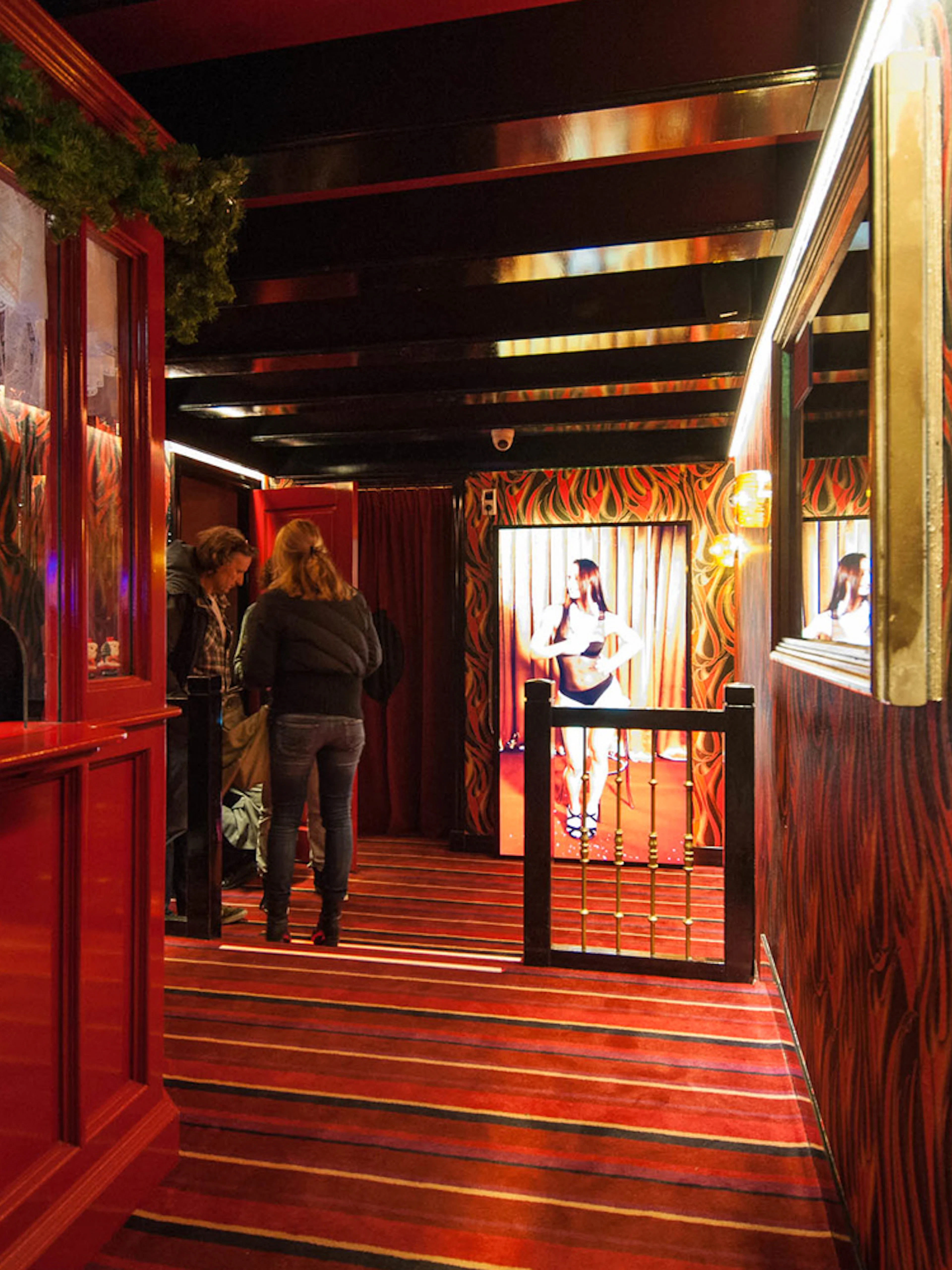 Interior of Museum of Prostitution in Amsterdam with visitors exploring exhibits.
