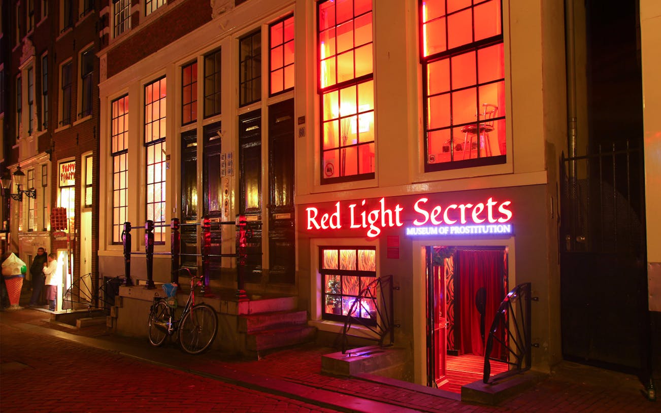 Red Light Secrets Museum entrance in Amsterdam's Red Light District at night.
