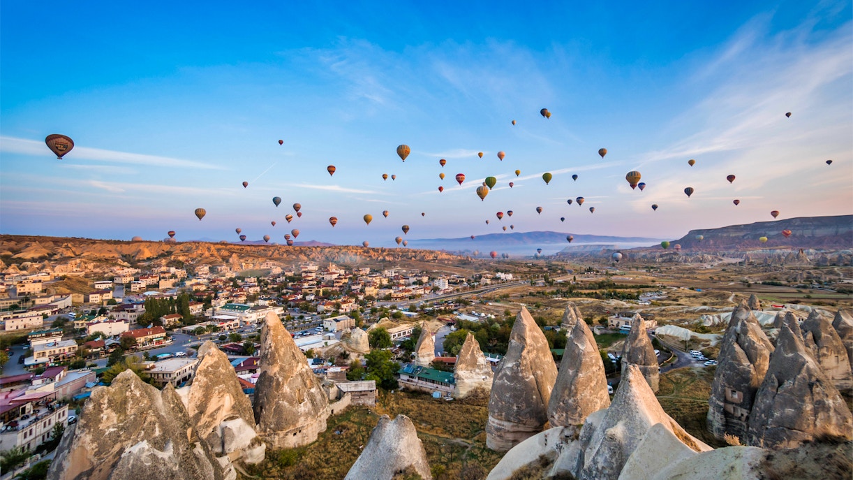 Cappadocia hot air balloons over rocky landscape during small group flight.