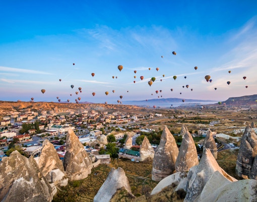 Cappadocia hot air balloons over rocky landscape during small group flight.