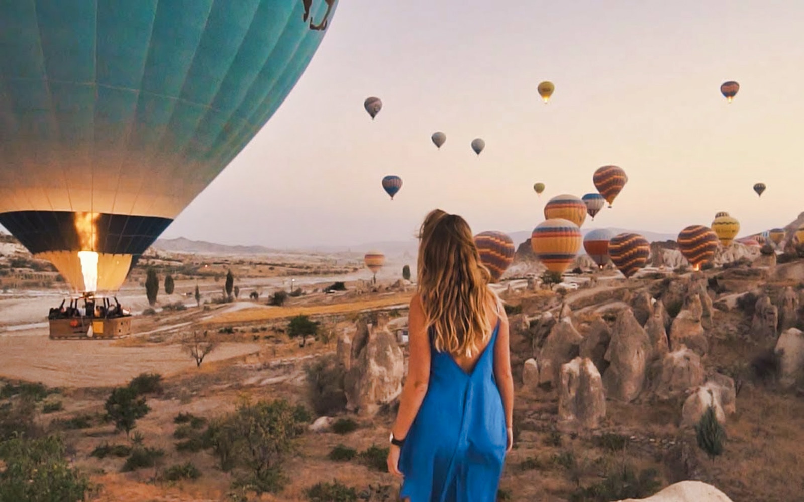 Hot air balloons over Cappadocia landscape during small group tour with Goreme Open-Air Museum.