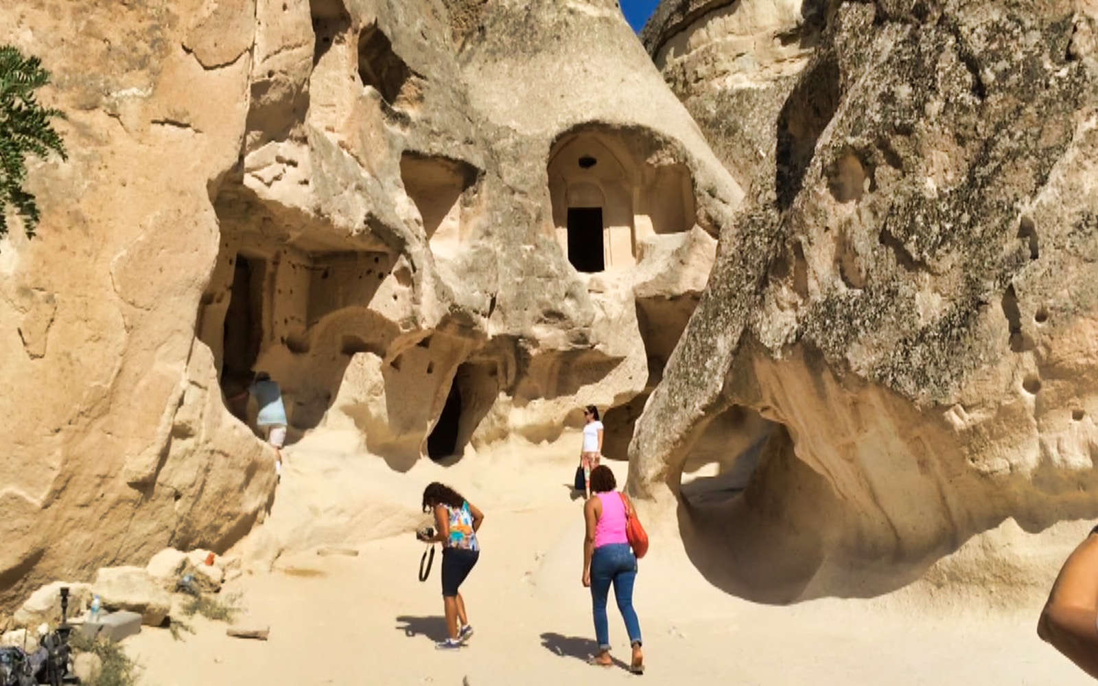 Visitors exploring rock formations at Goreme Open-Air Museum, Cappadocia.